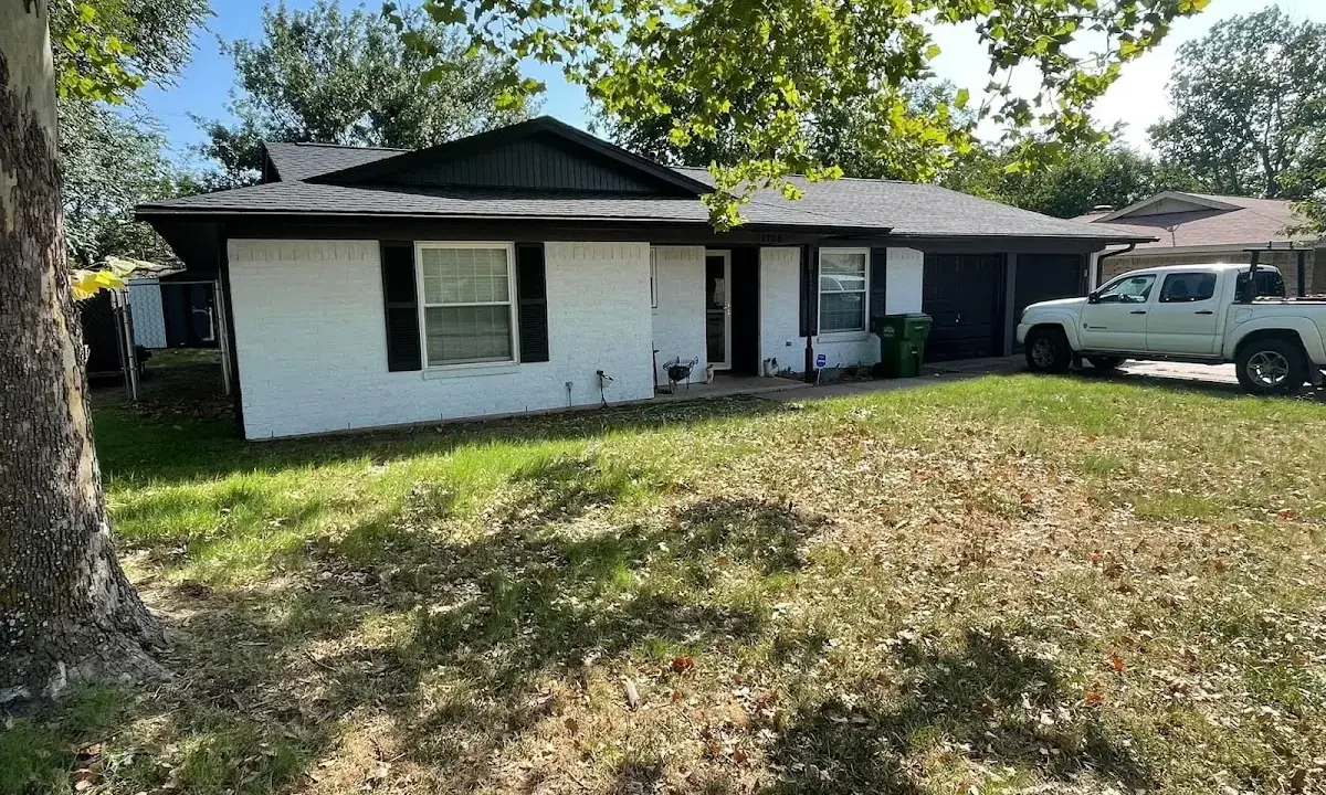 Professional roofing crew working on a residential roof in Dunbar